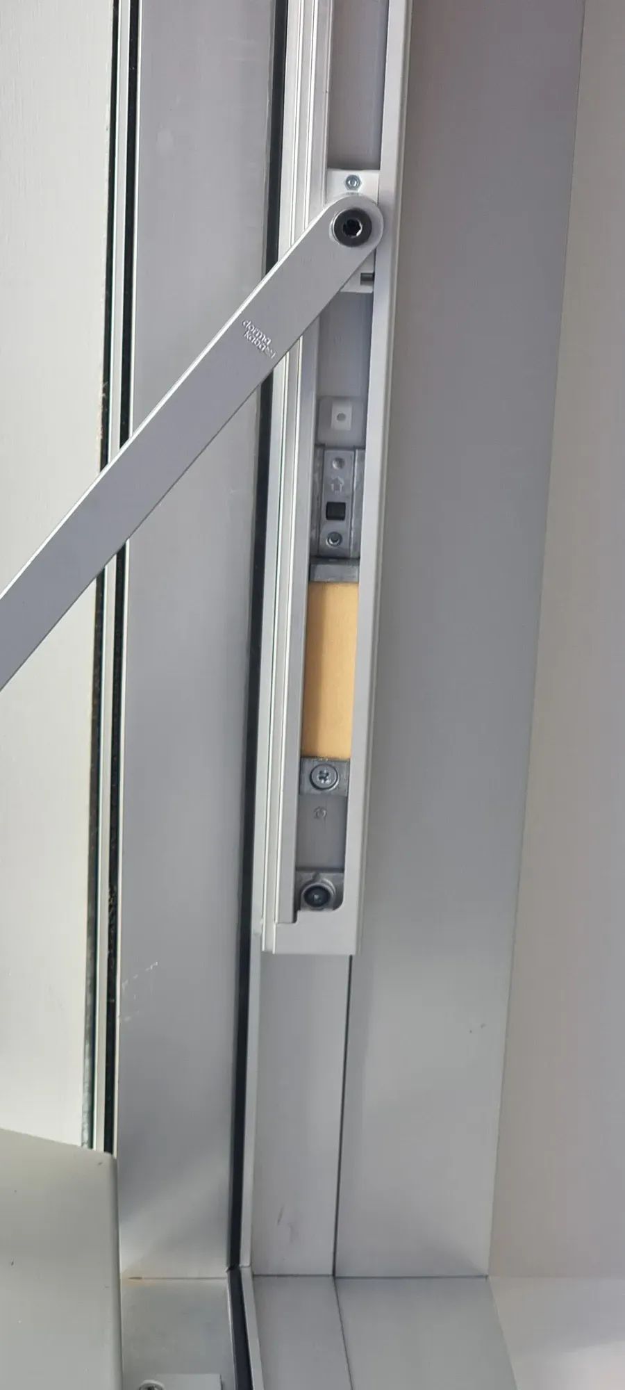 An electric release lock in an aluminium door frame
