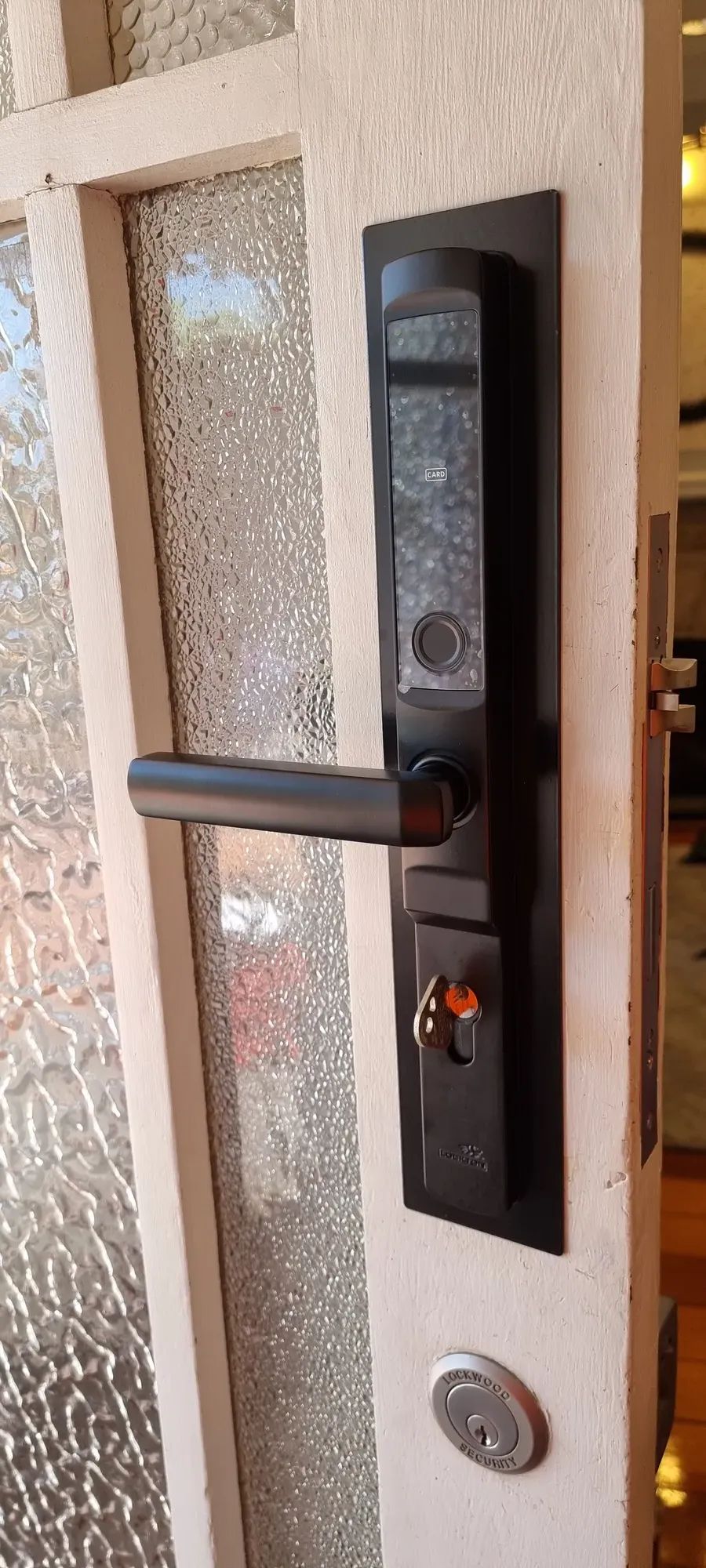 A smart lock handle on a timber door