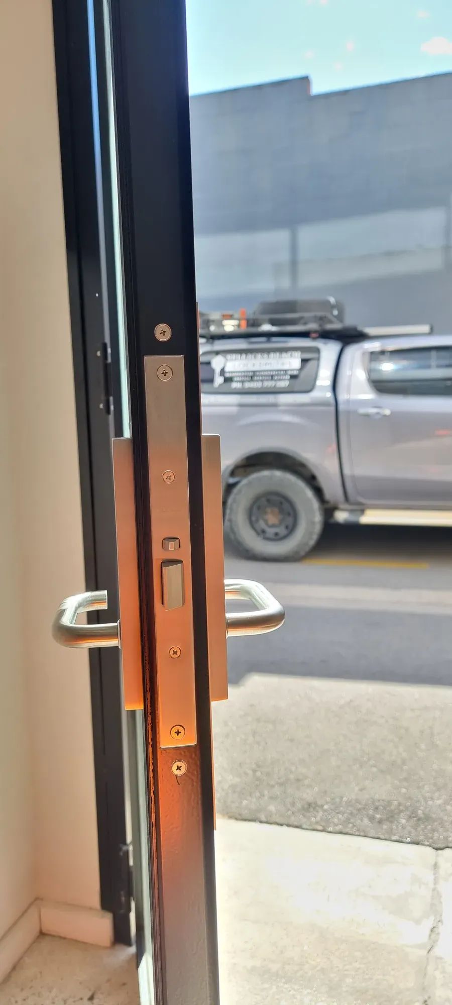A lock on a commercial glass door