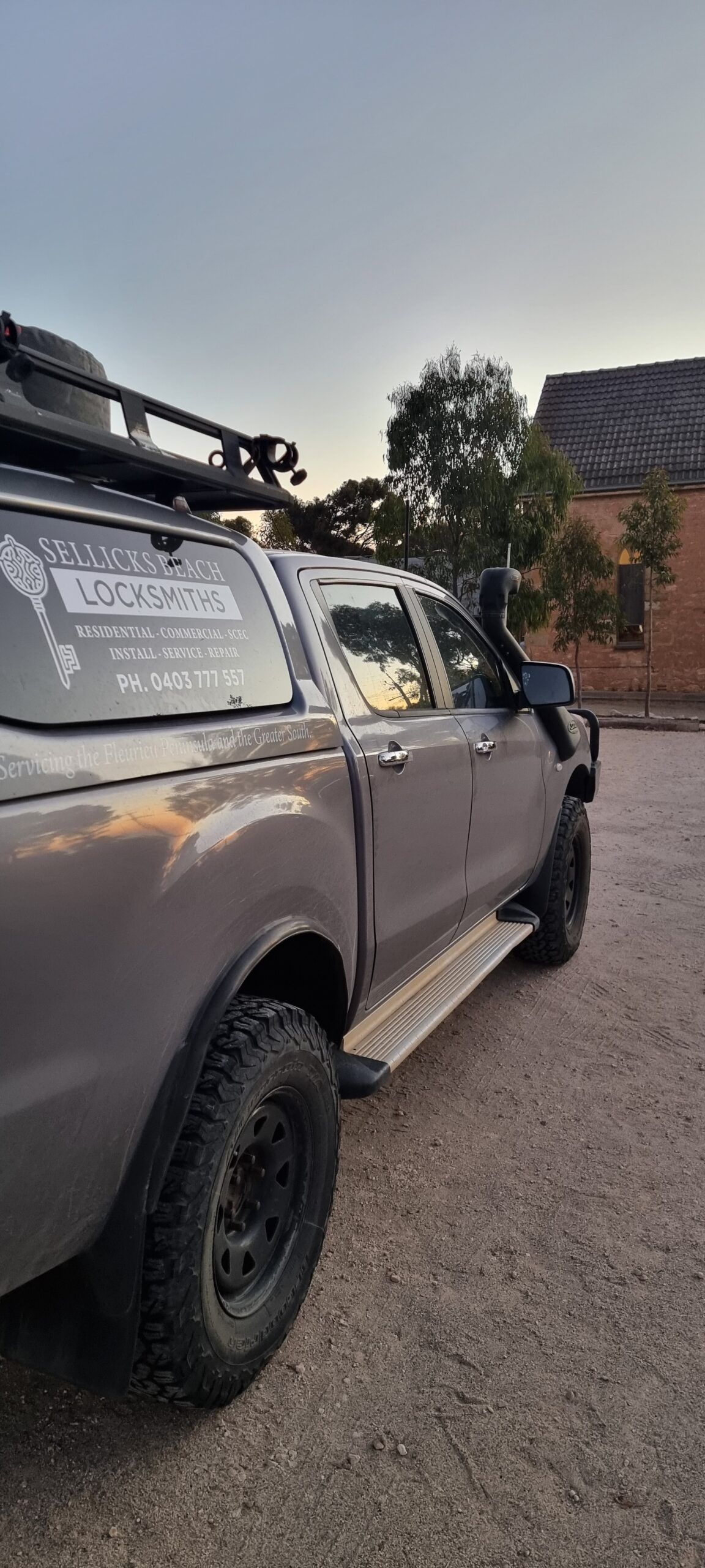 Doug’s ute at dusk, with the roof rack and canopy of the mobile locksmith workshop